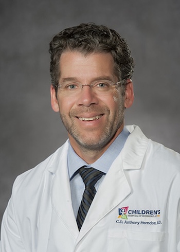 Dr. Tony Herndon in a white medical coat