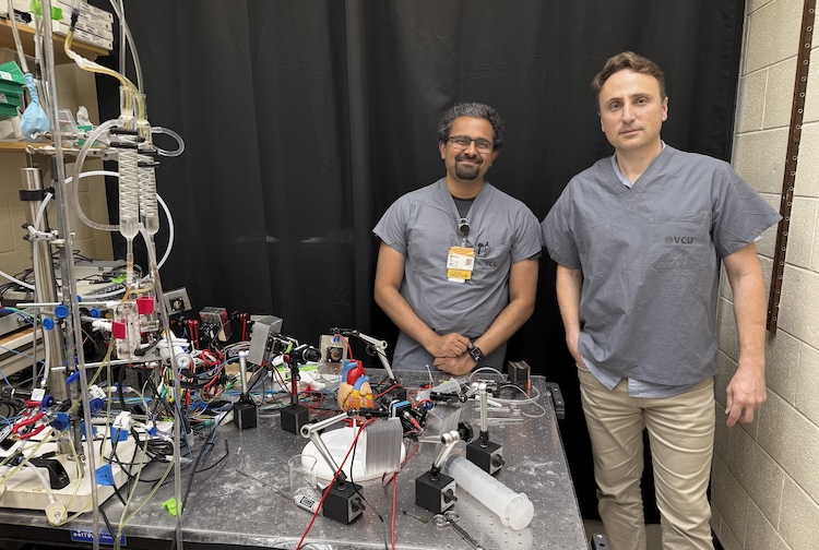 Picture of Ajay Pillai, M.D. (left), and Ilija Uzelac, Ph.D. (right) standing next to each other in front of the SurePace model