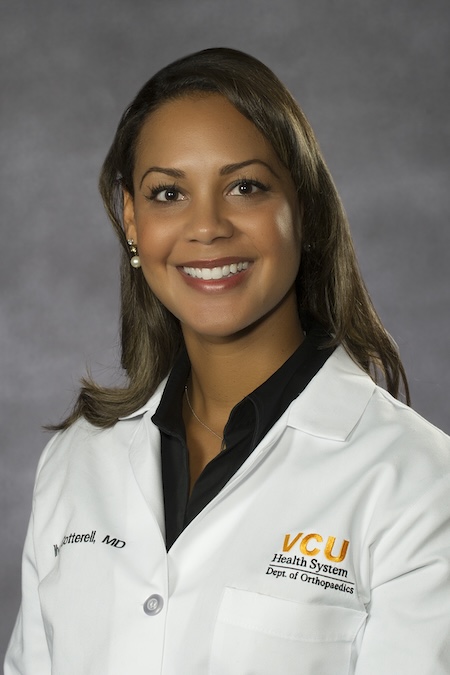 Dr. Cotterell wearing a black blouse along with her VCU Health white coat.