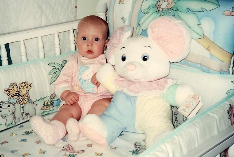 Baby with a stuffed mouse toy
