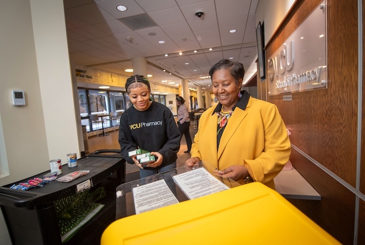 Janet and a student are reviewing information for the pantry located at the school