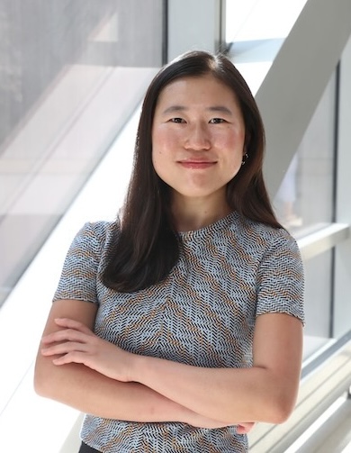 Dr. Wu wearing a pattern shirt and with her arms folded.
