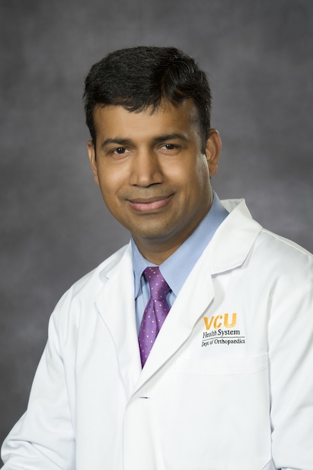 Dr. Satpathy wearing his VCU Health white coat.