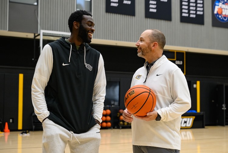 Joe and Dr. Cheatham on the VCU basketball court at the Stuart C. Siegel Center