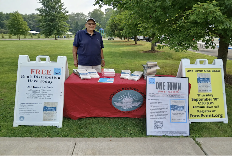 John Senior at a tabling event promoting a book.