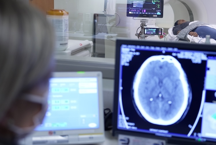 VCU Health team member looking at brain scans while patient is in MRI
