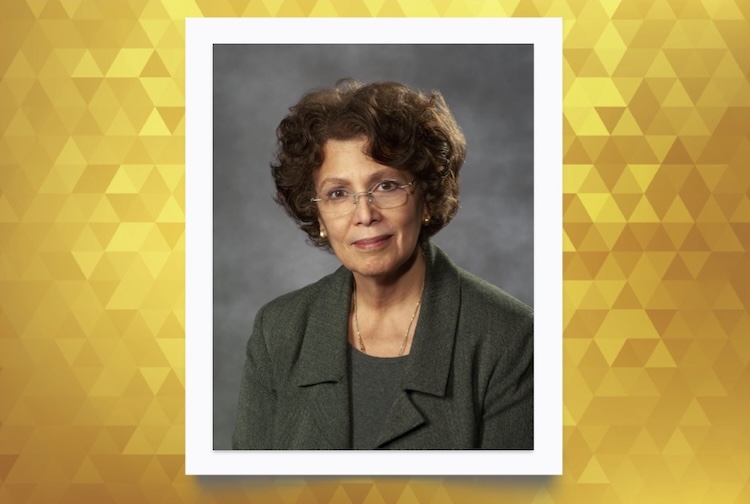 Dr. Karen Hendricks-Muñoz in a green suit.