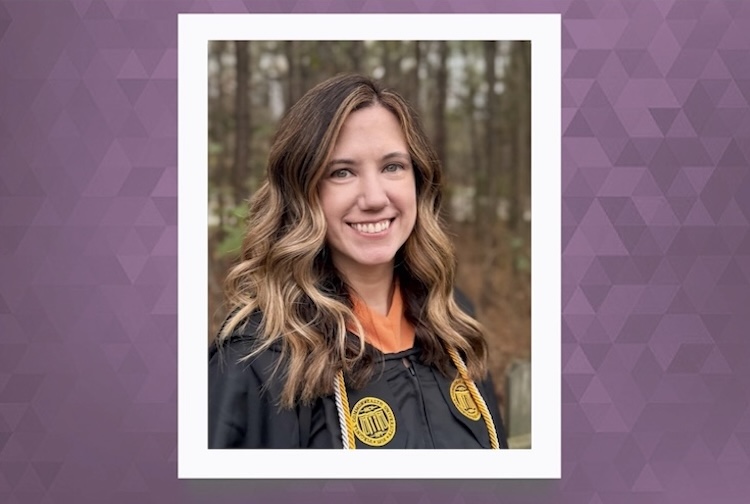Katie in her VCU graduation gown outside