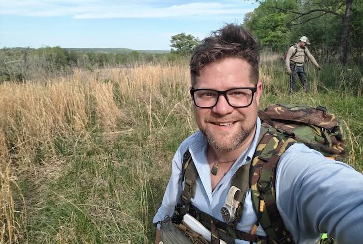 Keith takes a selfie in a field during a wilderness search and rescue training