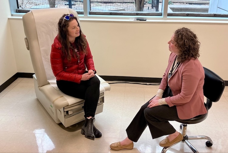 Rani Thompson speaking with patient Kelsey Bracewell in a patient room