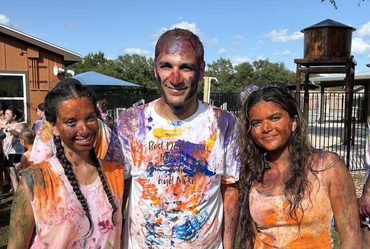 Dr. Khan, Soni and Patel smile after being covered in paint by campers