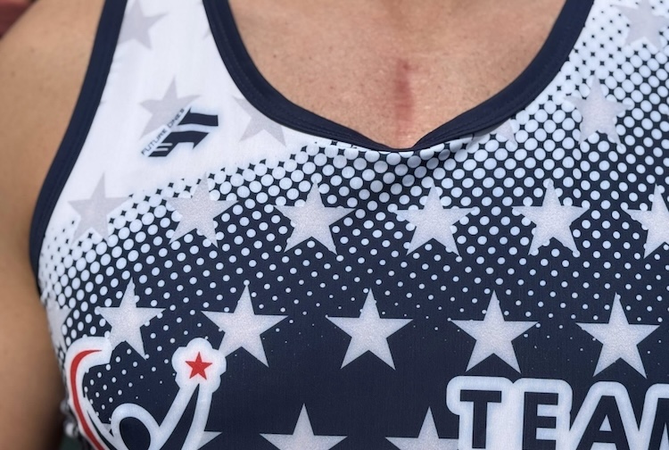 A small scar appears on Kyle’s chest above his jersey