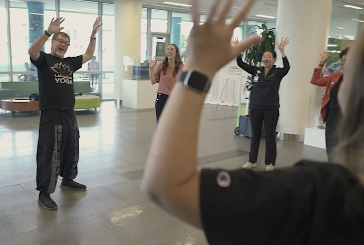 Group of people in a circle with their hands raise