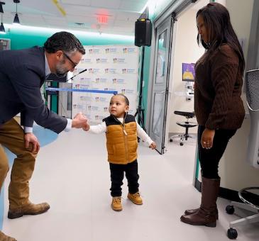 Hugh Cline and Lennox Crutchfield share a handshake