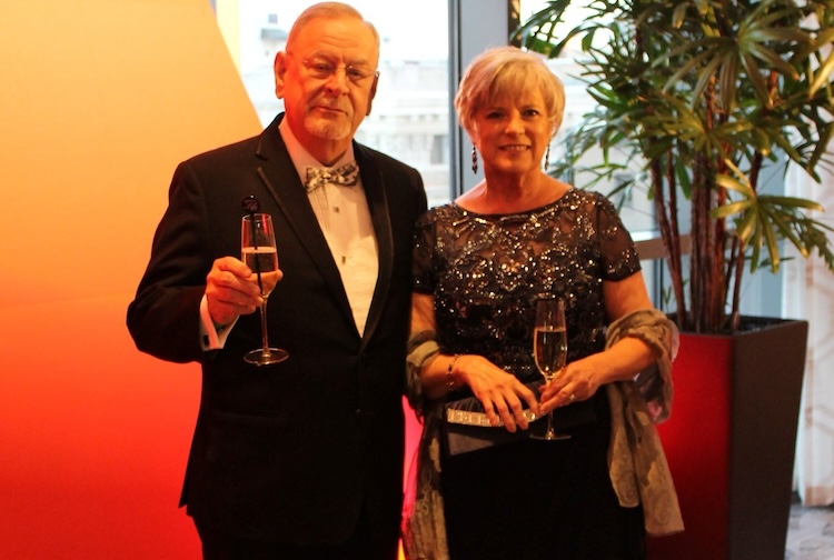Man standing with woman all dressed up for a gala