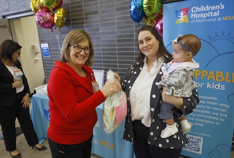 Lisa Ripp holding donation with Jillian Prez