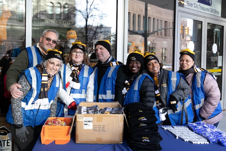 Volunteers smiling with VCU Health hats