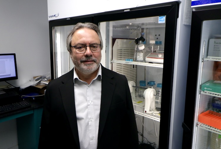 Marconi in front of fridge in a lab.