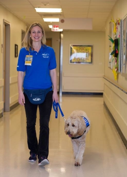 Margaret walking Elsa through the hallway