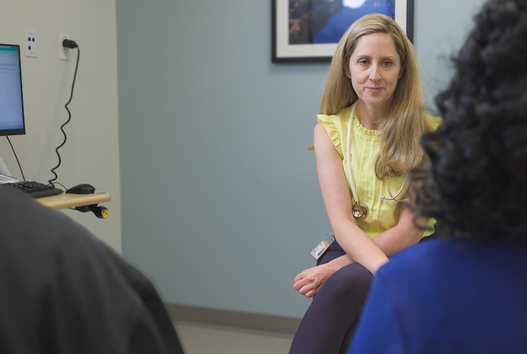 Dr. Maher speaking with a patient and her family.