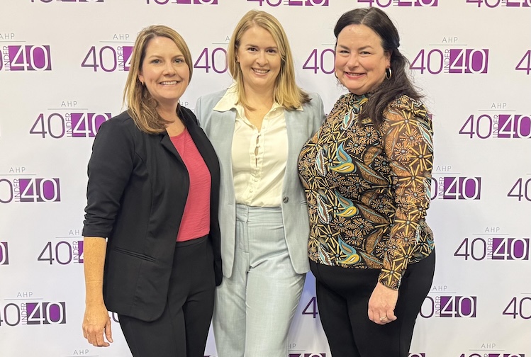 Three women gathered for a photo