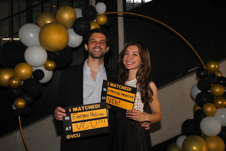 Guiliano and Mikayla holding up their VCU Matched signs together