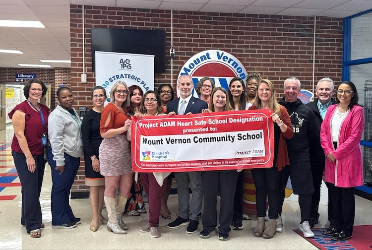 A group of Mount Vernon Community School employees with Dr. Phillips for a photo after doing a Project ADAM training.