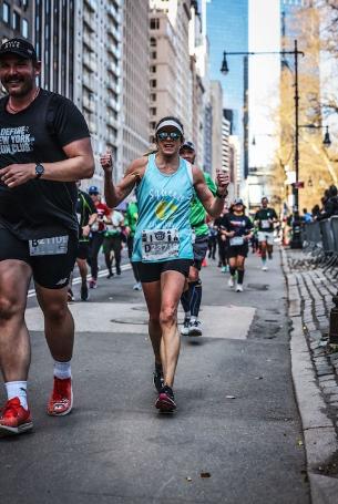 Beth running down a city street