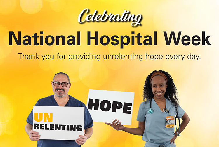 Team members hold up signs saying unrelenting hope