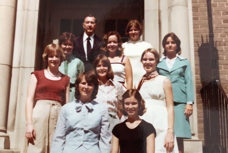 Color picture from 1977 of pediatrics nurse practitioners standing outside of a building.