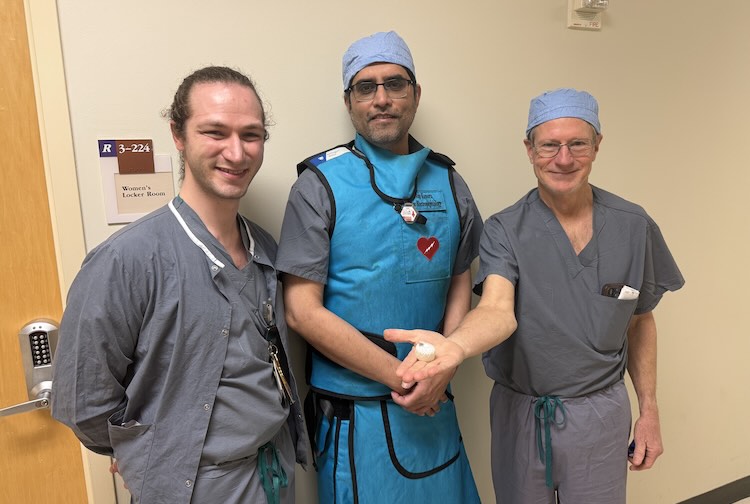Three VCU Health Pauley Heart Center team members pose for a photo in scrubs