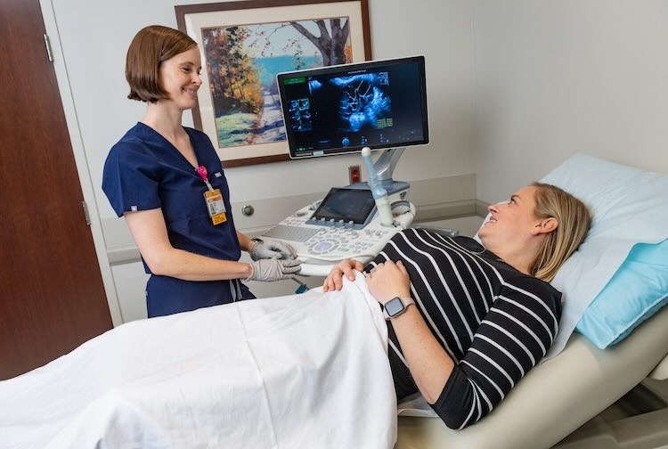 Dr. New speaks with a patient who had a sonogram.
