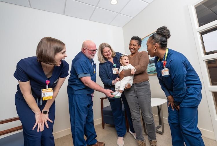 VCU Health doctors and nurses celebrate a baby and mother.