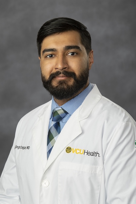 Dr. Chaggar wearing his VCU Health white coat.