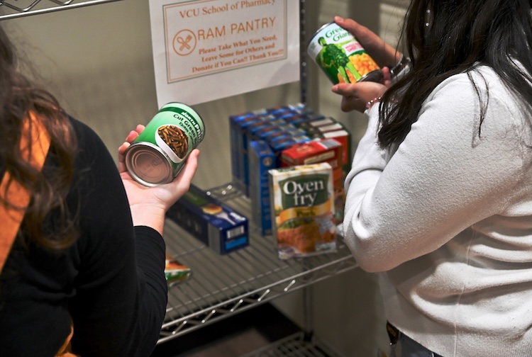 Two people looking at tickets in the food pantry