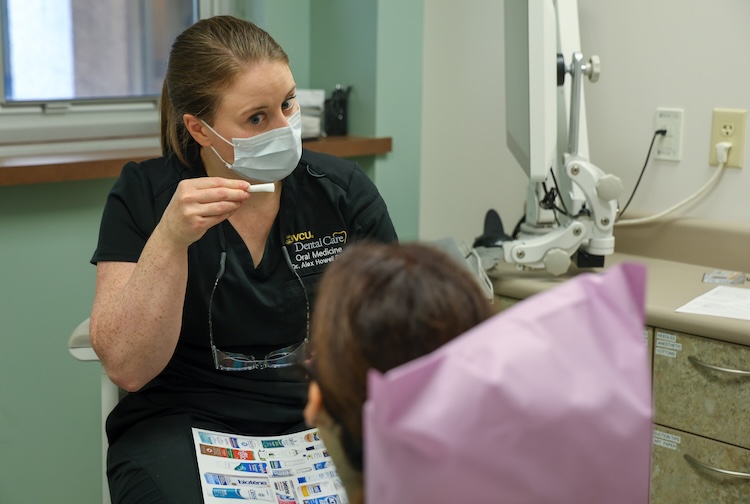 Dr. Alex Howell speaks with a patient