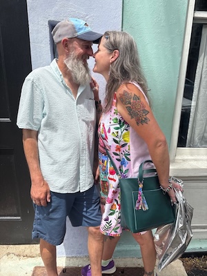 Rick and Tracey lean into each other smiling with their foreheads touching