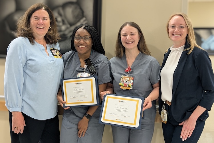 Four women stand together with certificates for STAR Service Awards