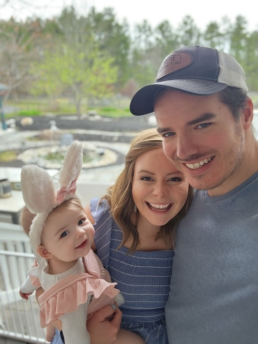 Breast cancer survivor with husband and baby at Easter