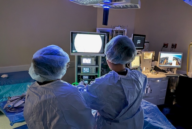 High schoolers perform a mock surgery in a staged operating room during camp