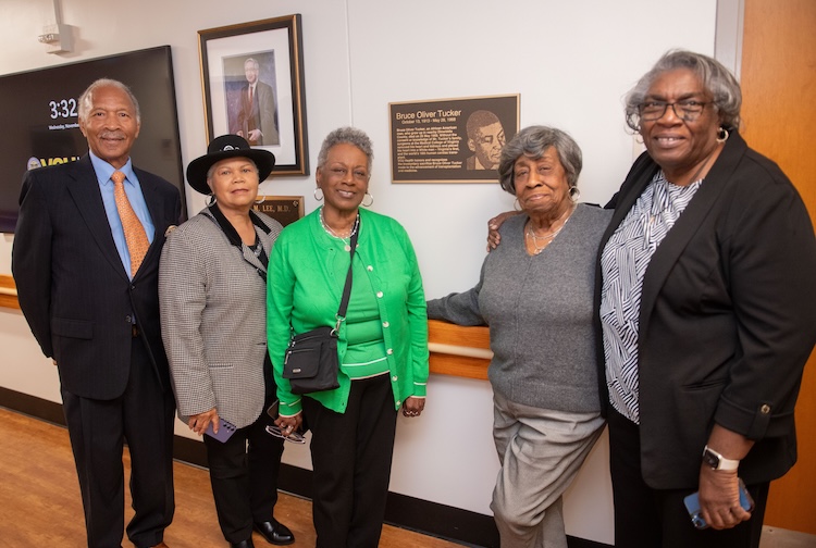 Family members stand near signage at VCU Health honoring Bruce Oliver Tucker