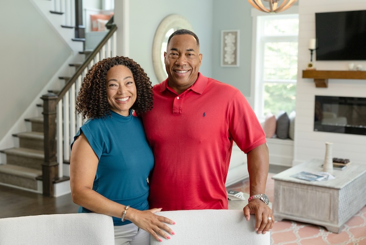 Quan and Johnny Boatman smile in their living room.