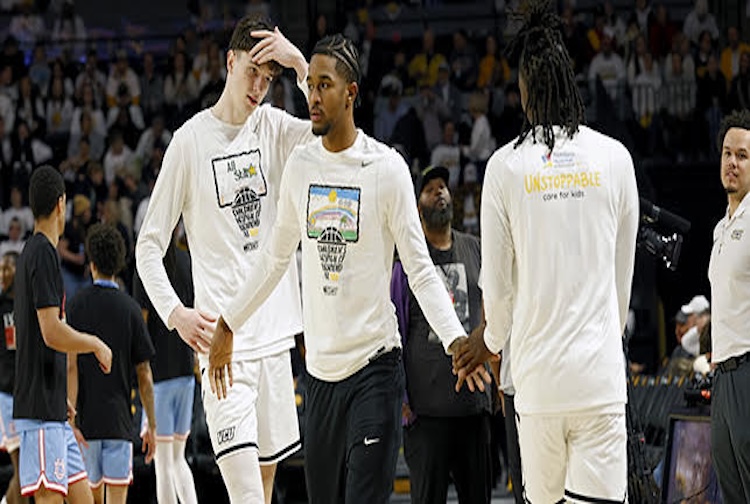 VCU Rams Basketball players on the court wearing special shooting shirts in collaboration with the Children Hospital of Richmond.