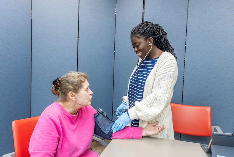 VCU nursing student takes blood pressure of a local woman