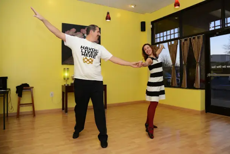 man and women dancing in ballroom