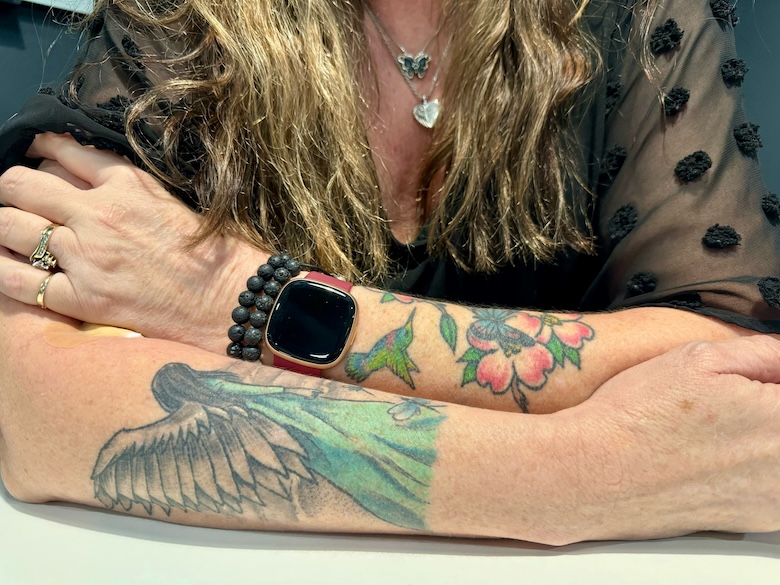 Woman's arms with tattoos