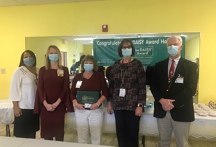 Alfreda Brown, RN; Megan Gardner, RN, MSN, CHPN; Connie Puryear, RN, BSN; Mary Hardin, MSN, RN, OCN, NE-BC; Scott Burnette, FACHE, CEO, gather to honor The DAISY Award for Extraordinary Nurses® at VCU Health Community Memorial Hospital.