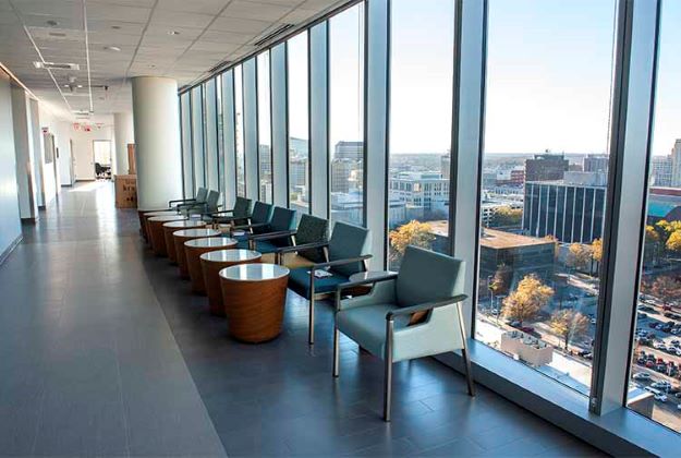 AOP hallway with tall windows overlooking skyline