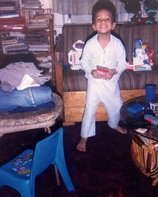Young boy standing in home smiling
