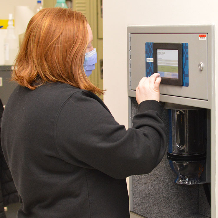 Ashley Acree, CPhT, loads medications into the tube system for delivery to a nursing station. Ashley lives in Emporia and has worked at VCU Health CMH for a few months.